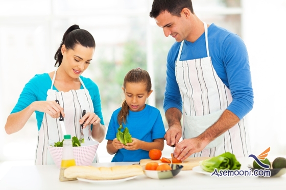 lovely young family preparing food in kitchen at home